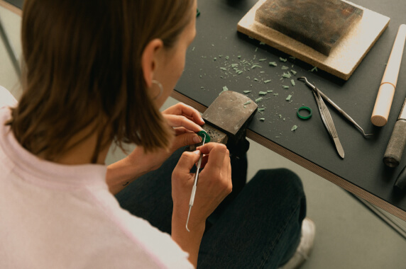 Artisan processing a piece of metal