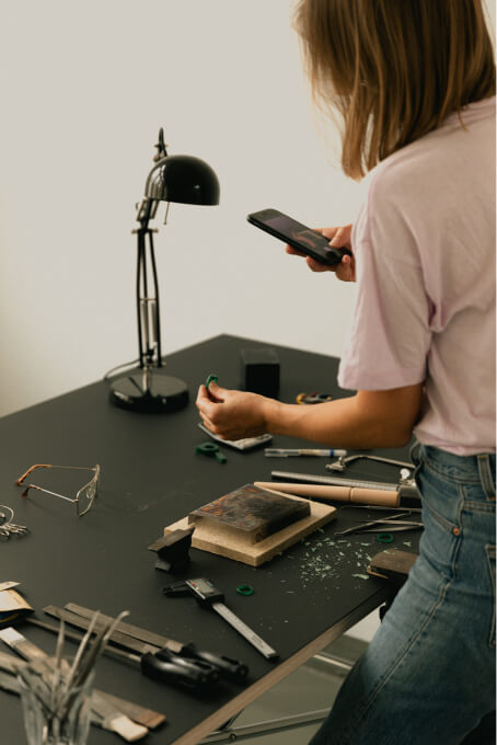 Artisan taking a photo of a work
